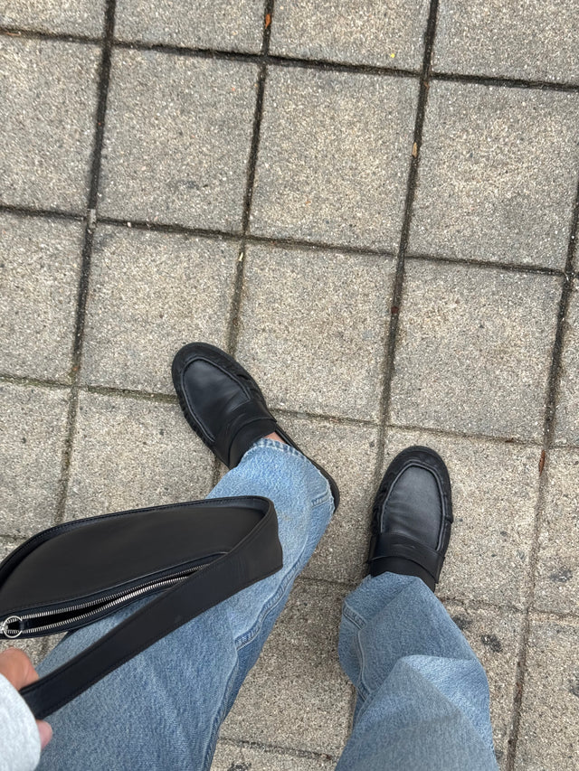 Yulia wearing black Proper Moccasins with denim.