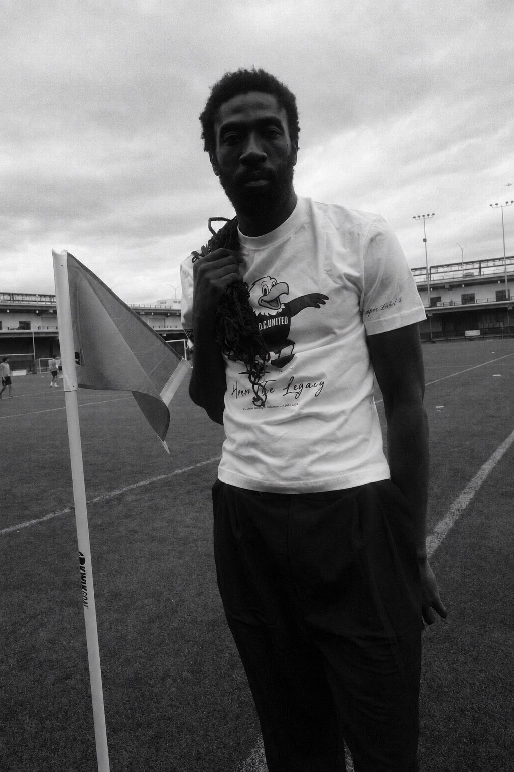 Camille Tanoh on an urban football pitch wearing The Proper Label D.C. United T-shirt