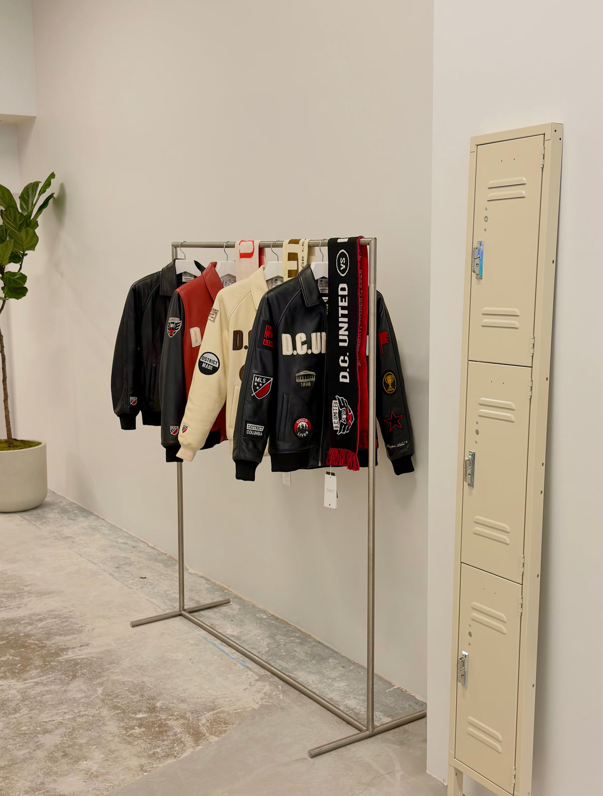 Four exclusive D.C. United jackets from The Proper Label MLS collaboration displayed at The Proper Stadium