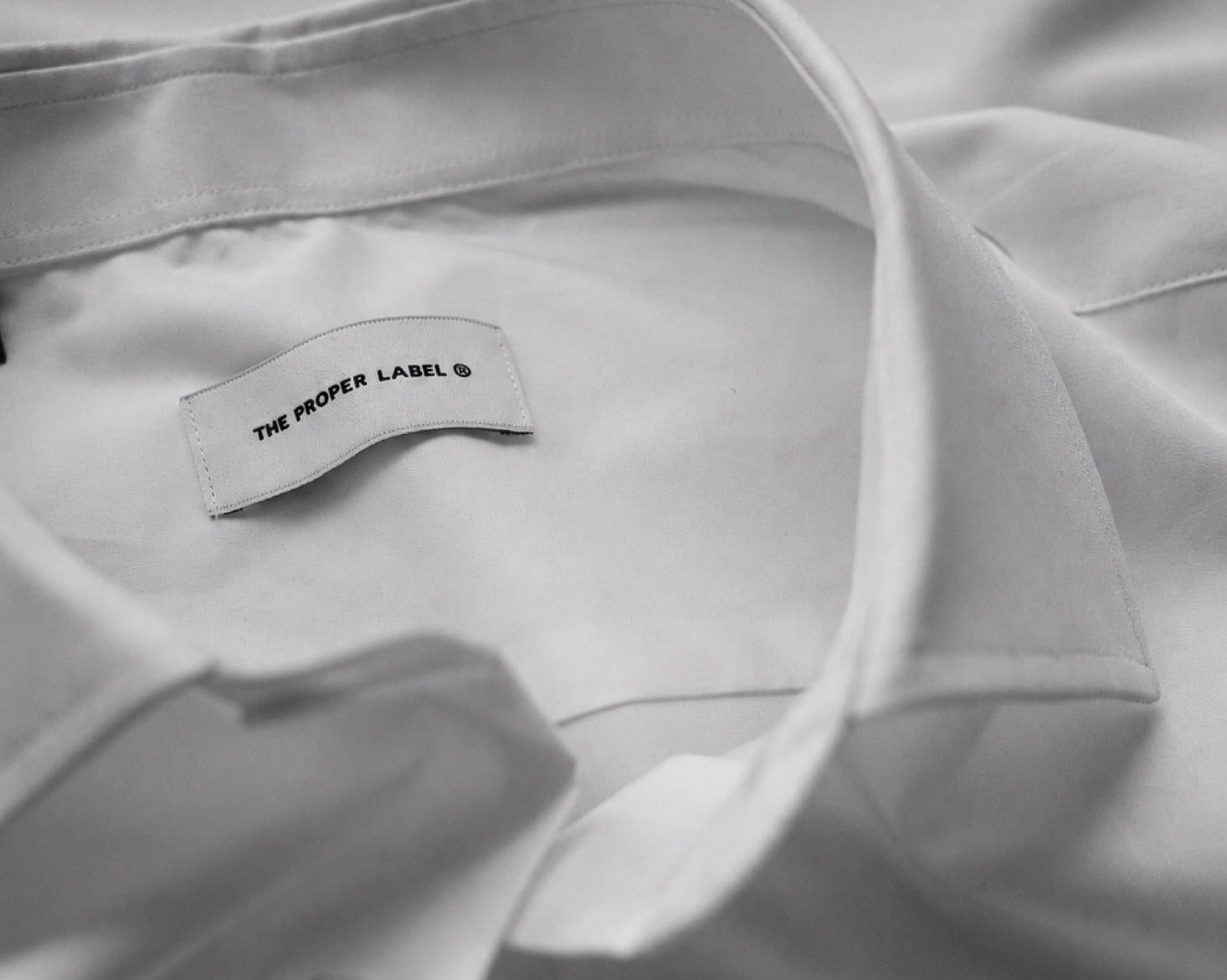 An observation of collars, buttons and the quiet surface of cloth.