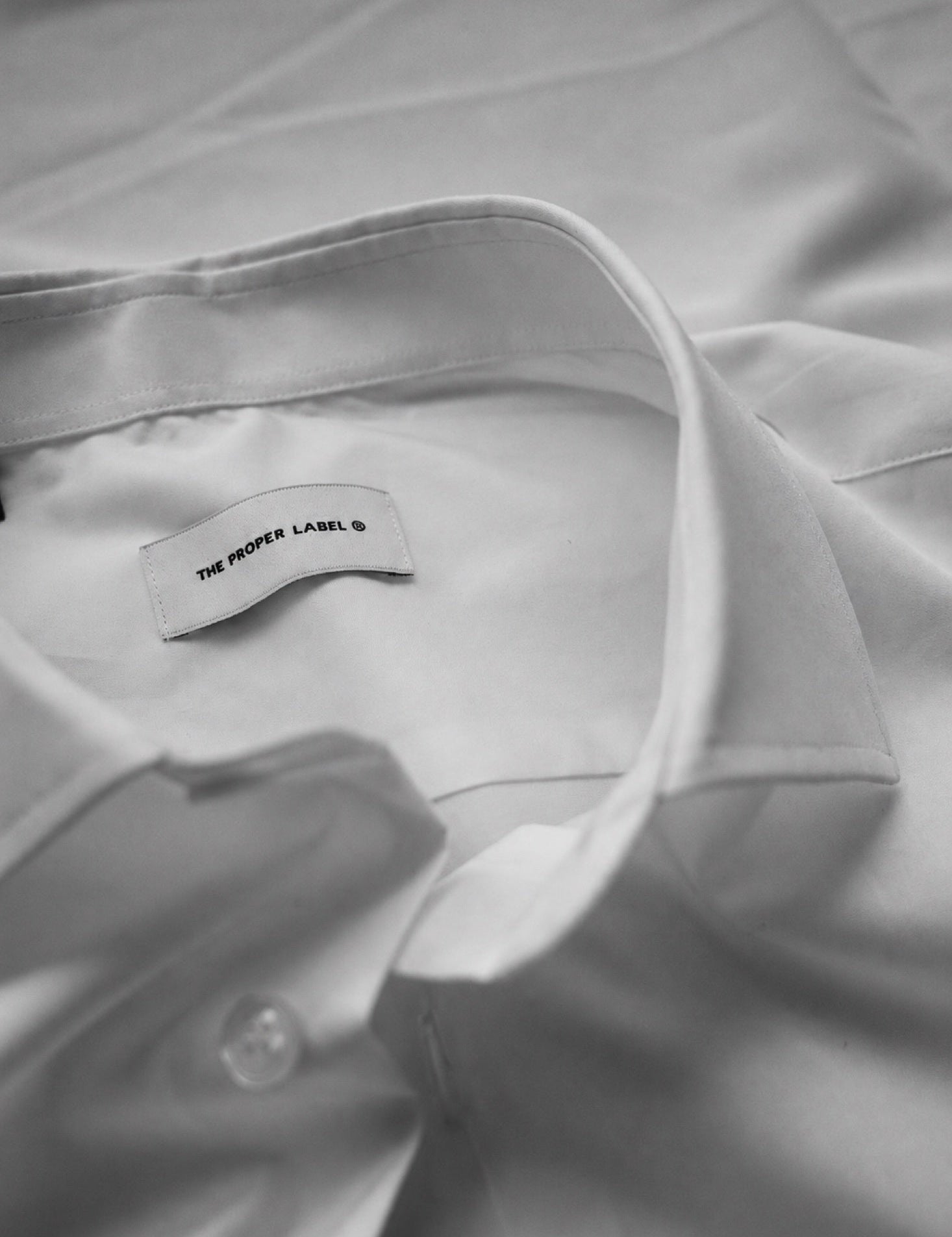 An observation of collars, buttons and the quiet surface of cloth.