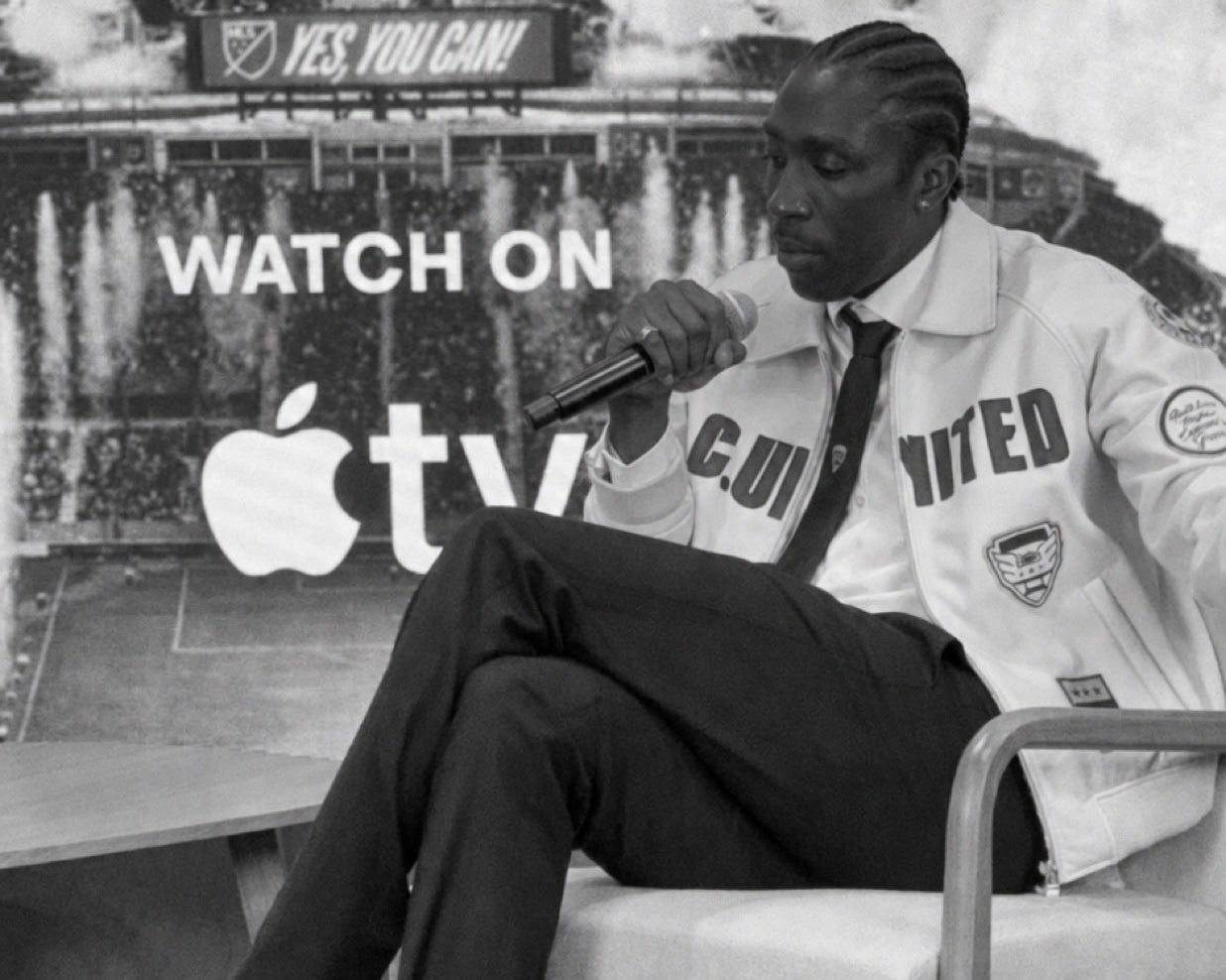 Camille Tanoh in conversation, with the club wardrobe close at hand.