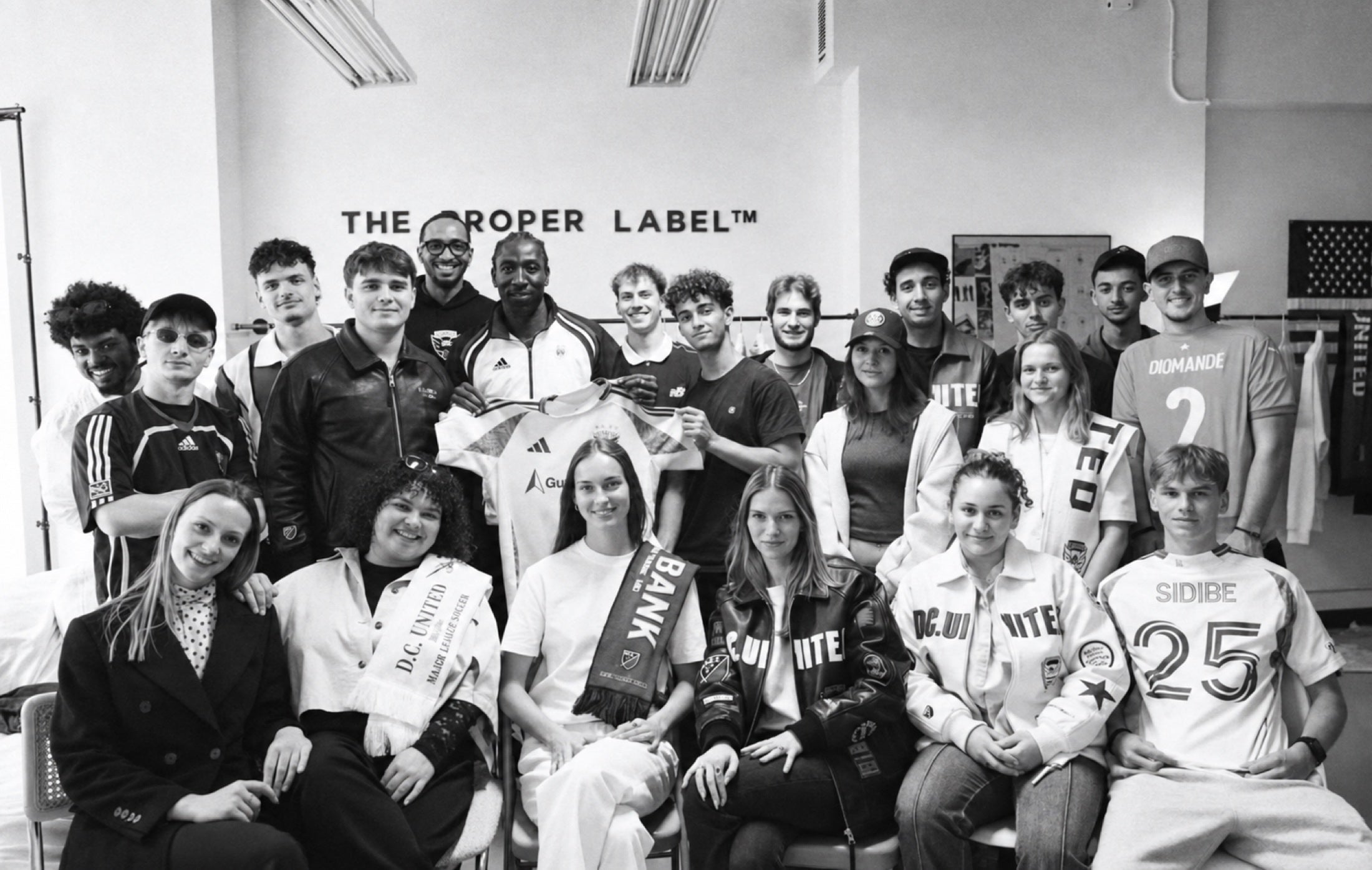 A group photograph, an open room and clothes that become a shared conversation.