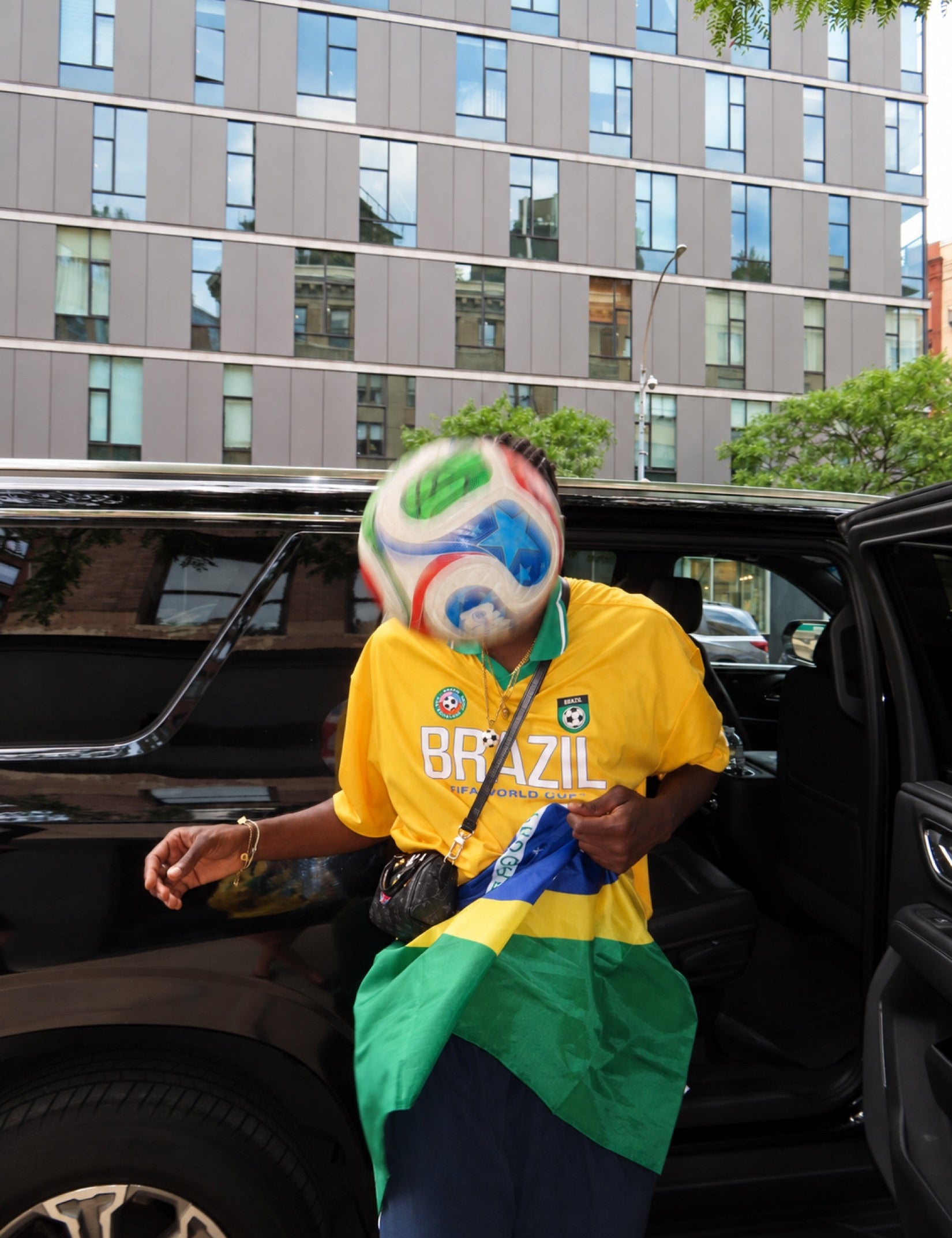 A moving ball interrupts an ordinary street photograph.