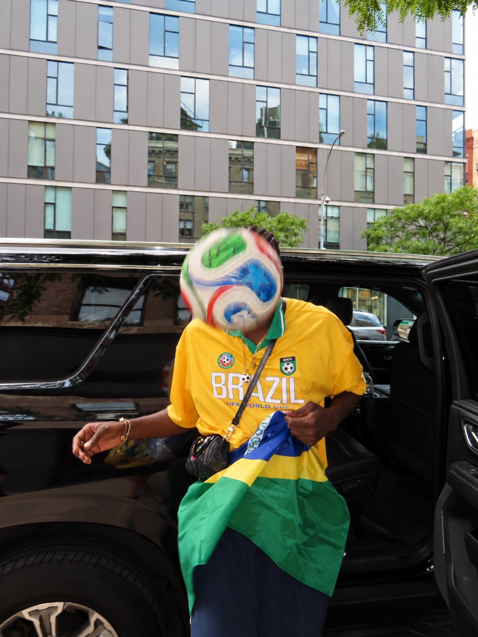 A moving ball interrupts an ordinary street photograph.