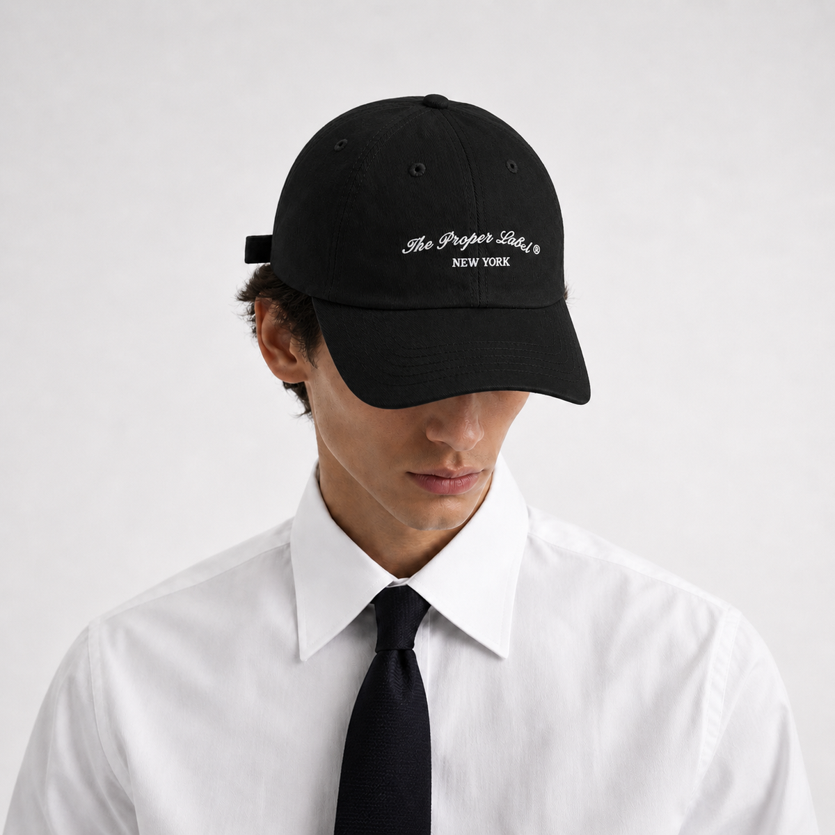 Signature Proper Cap — Noir — worn with white shirt and black tie