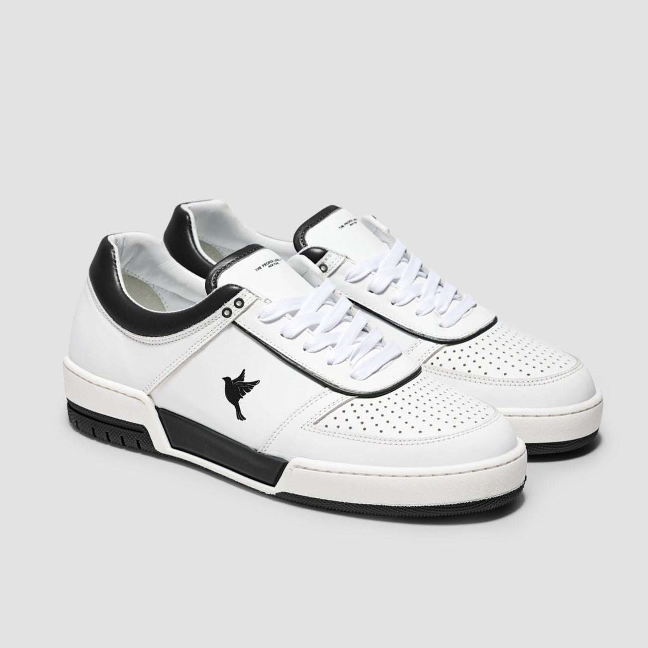 Sustainable sneakers made of durable with black and white color accents, showcasing a 3D-printed dove emblem on the side.