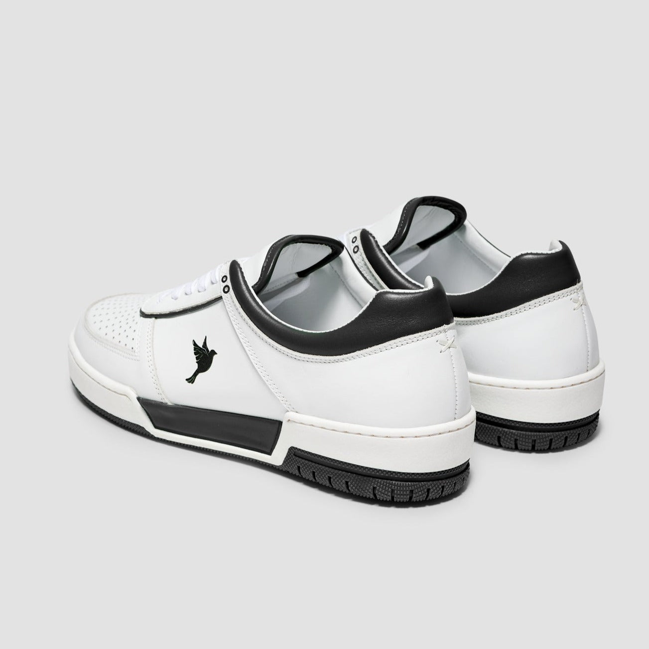Sustainable sneakers made of durable with black and white color accents, showcasing a 3D-printed dove emblem on the side.