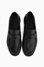 The Proper Moccasins® in black, pair viewed from above.