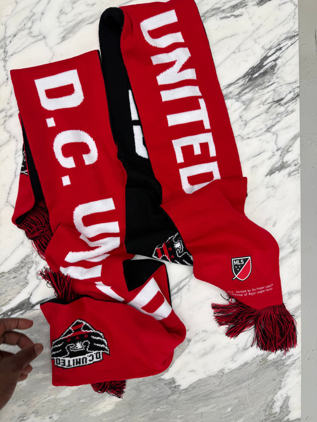 Lettrage en maille et franges d’une écharpe D.C. United.