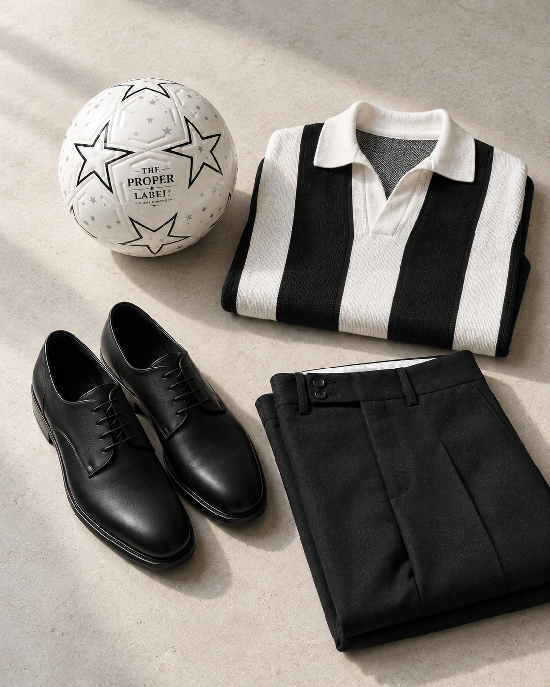 The Legacy Derby, Proper Starball, striped jersey and black wool trousers on a stone table.