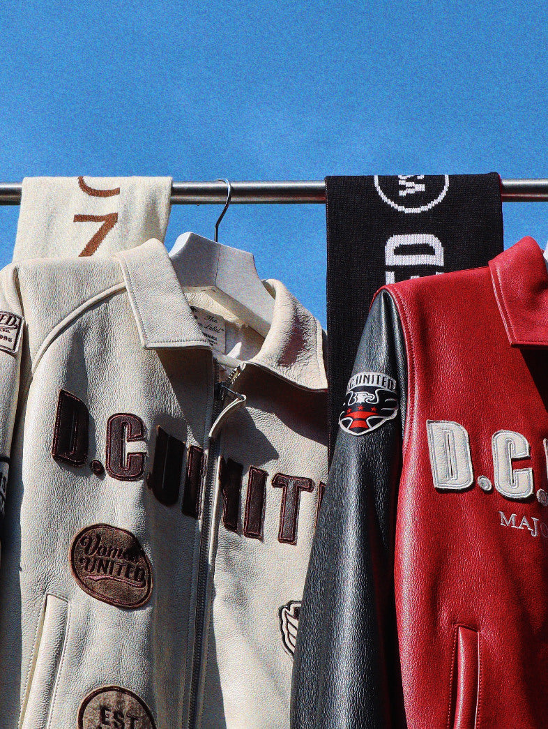 D.C. United leather jackets and scarves, photographed against the sky.