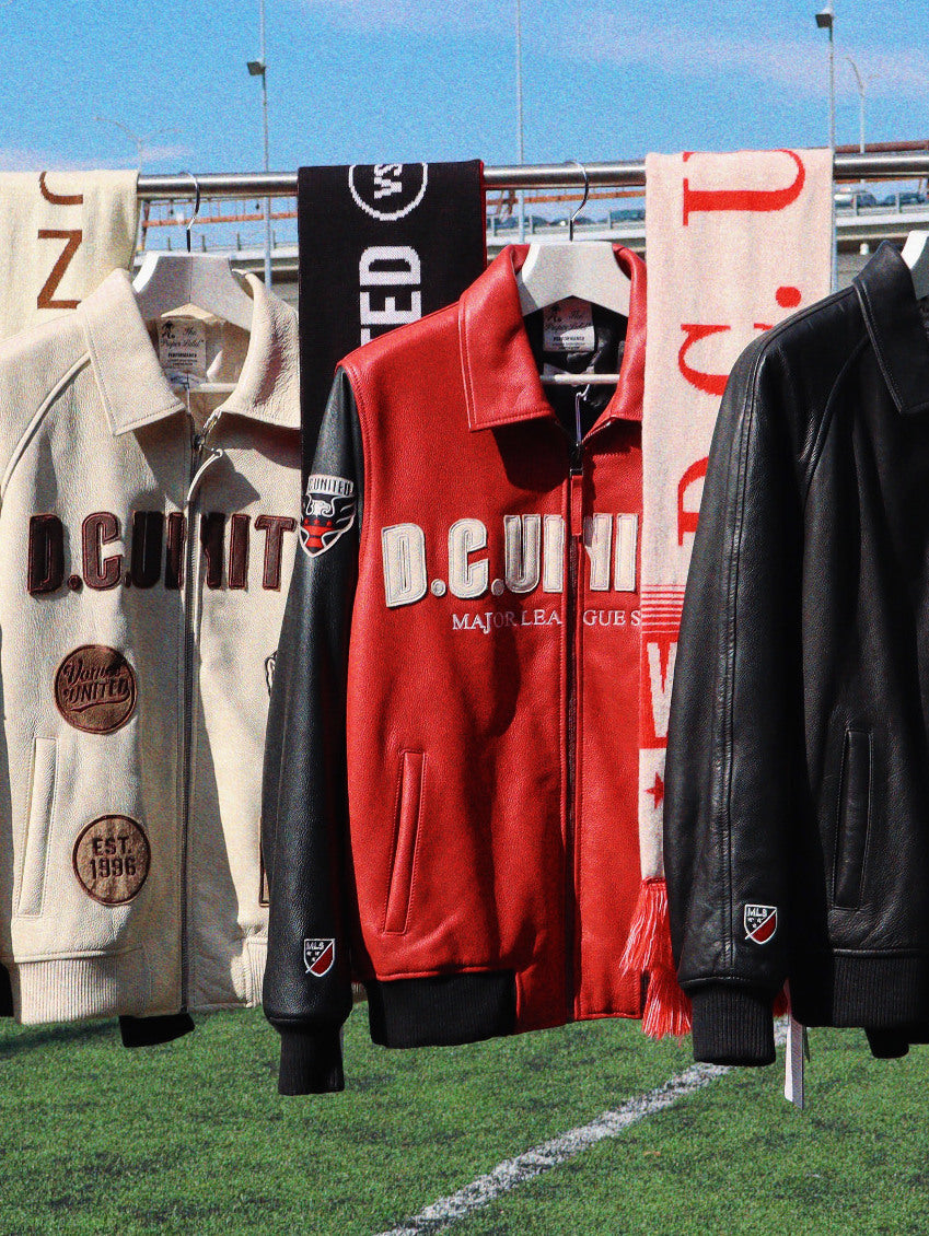 Black, ivory and red D.C. United leather jackets and scarves on a stadium rail.