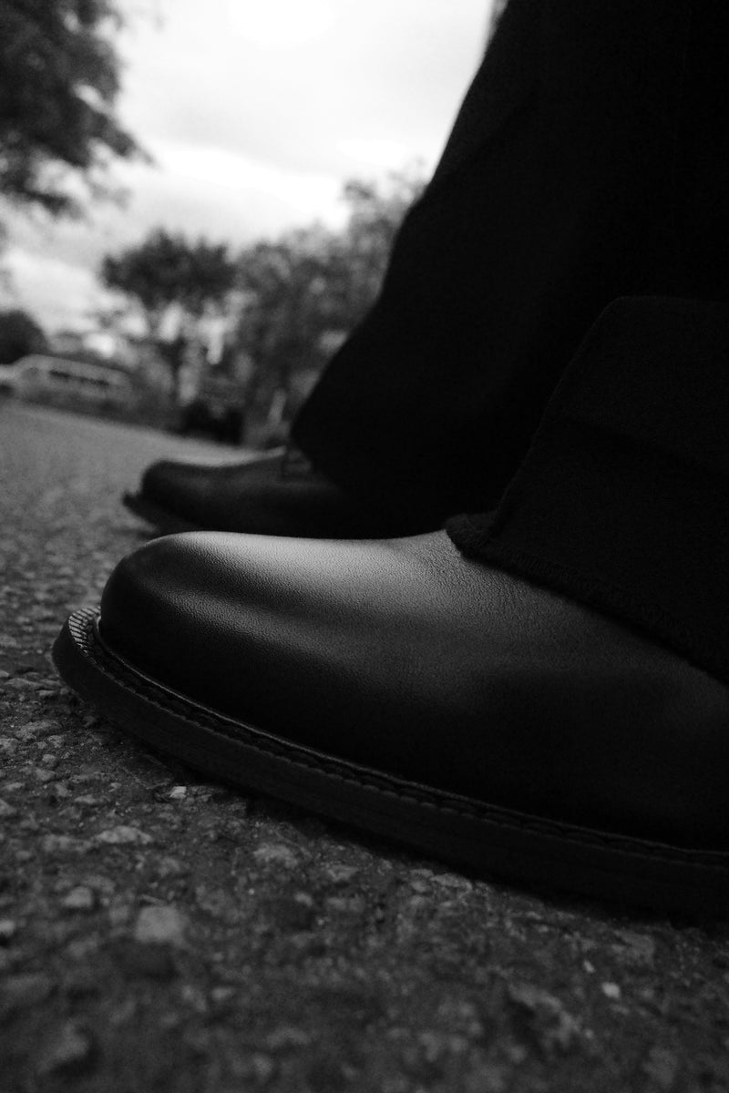 Black-and-white close-up of the Legacy Derby toe, leather grain, and sole.