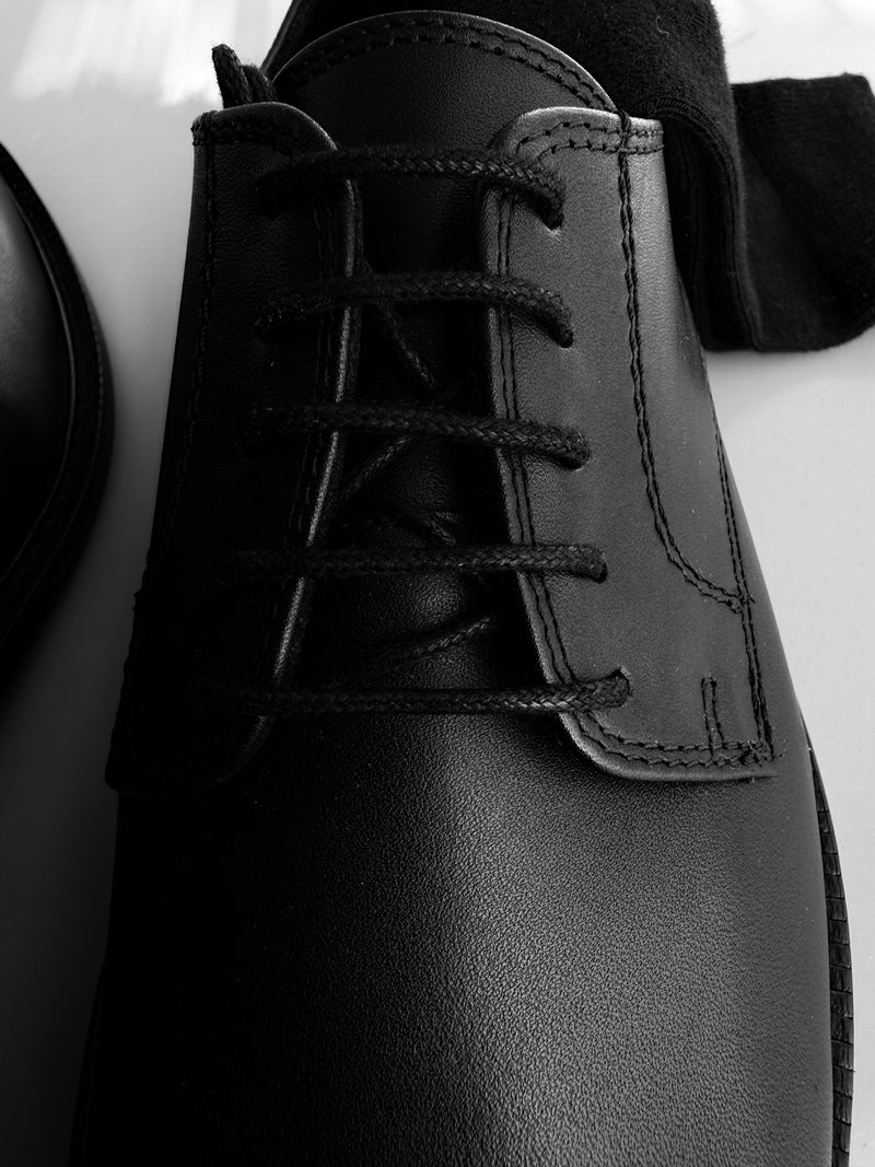Close-up of the Legacy Derby showing the black leather, stitching and five-eyelet lacing.