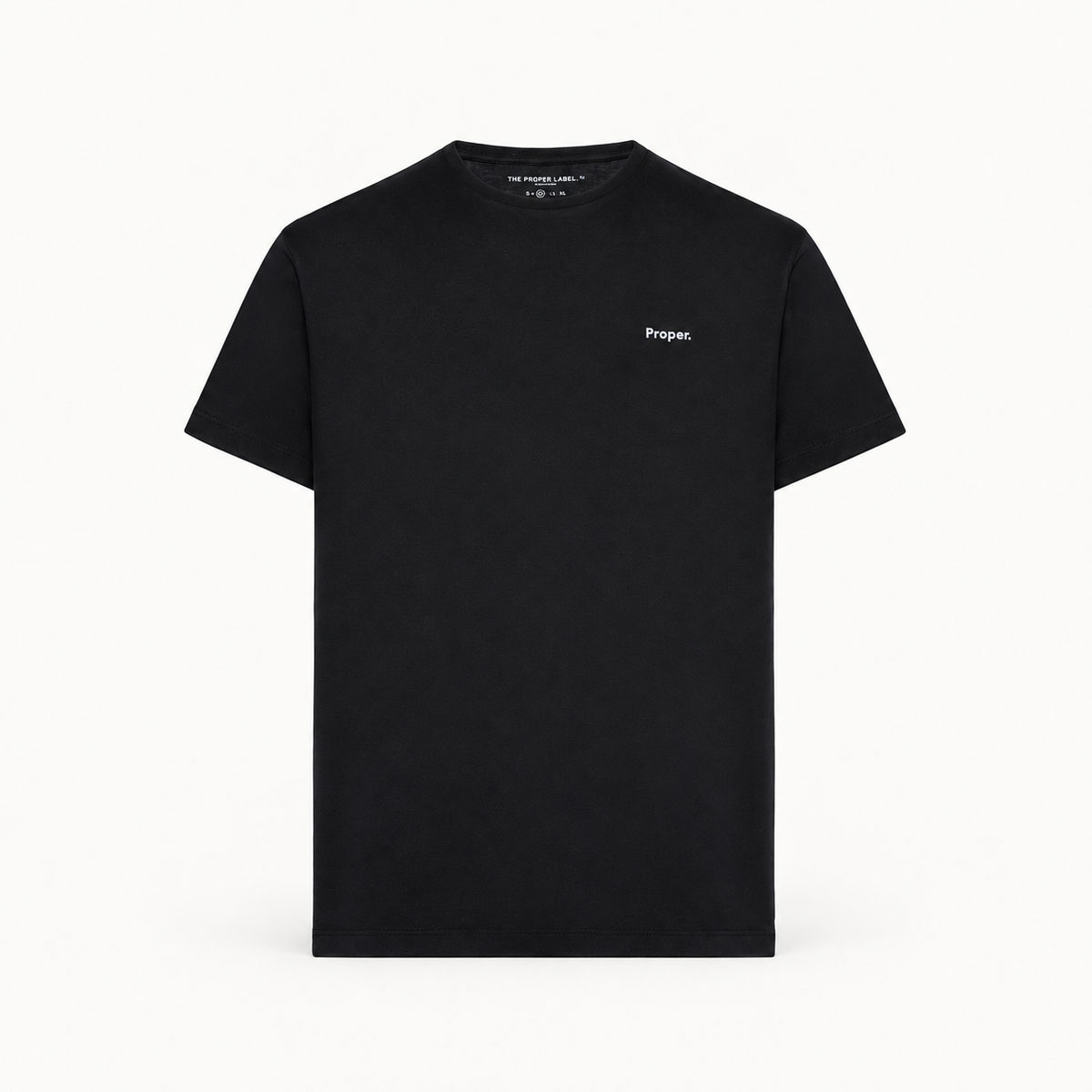 Essential T-shirt — black — single product view on the Maison studio background.