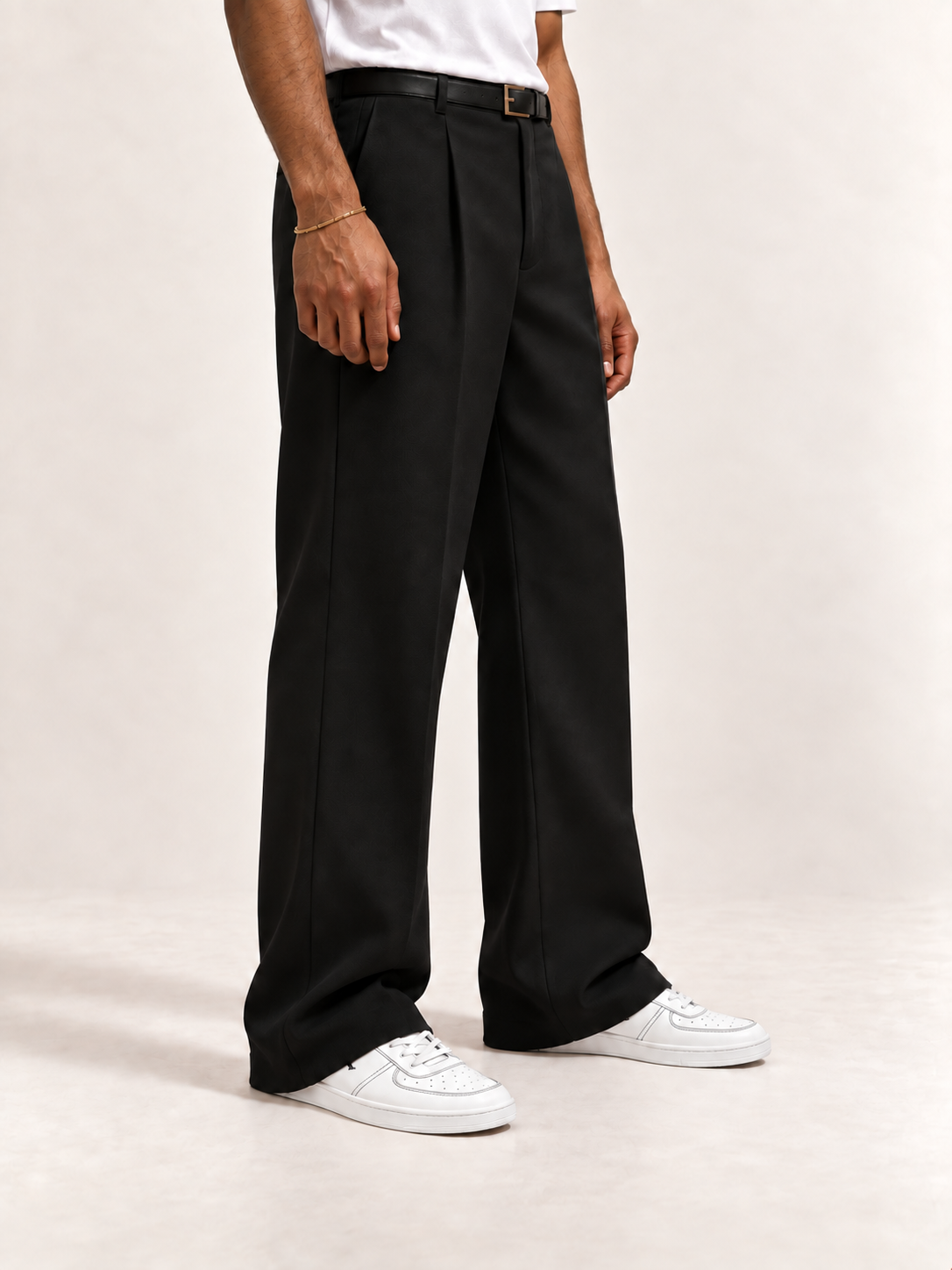 Proper Fly white and black sneakers with straight black trousers and a white T-shirt.