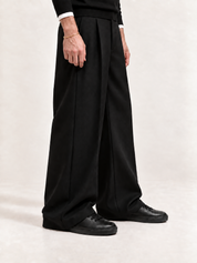 Proper High-Top black sneakers with straight black trousers, black knitwear and white cuffs.