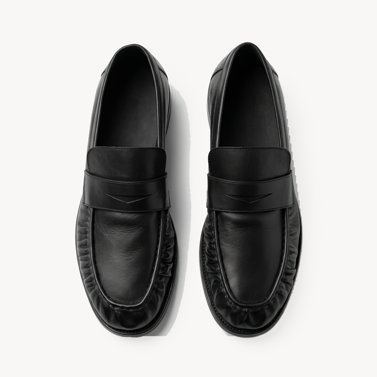 The Proper Moccasin, black leather loafers — pair viewed from above