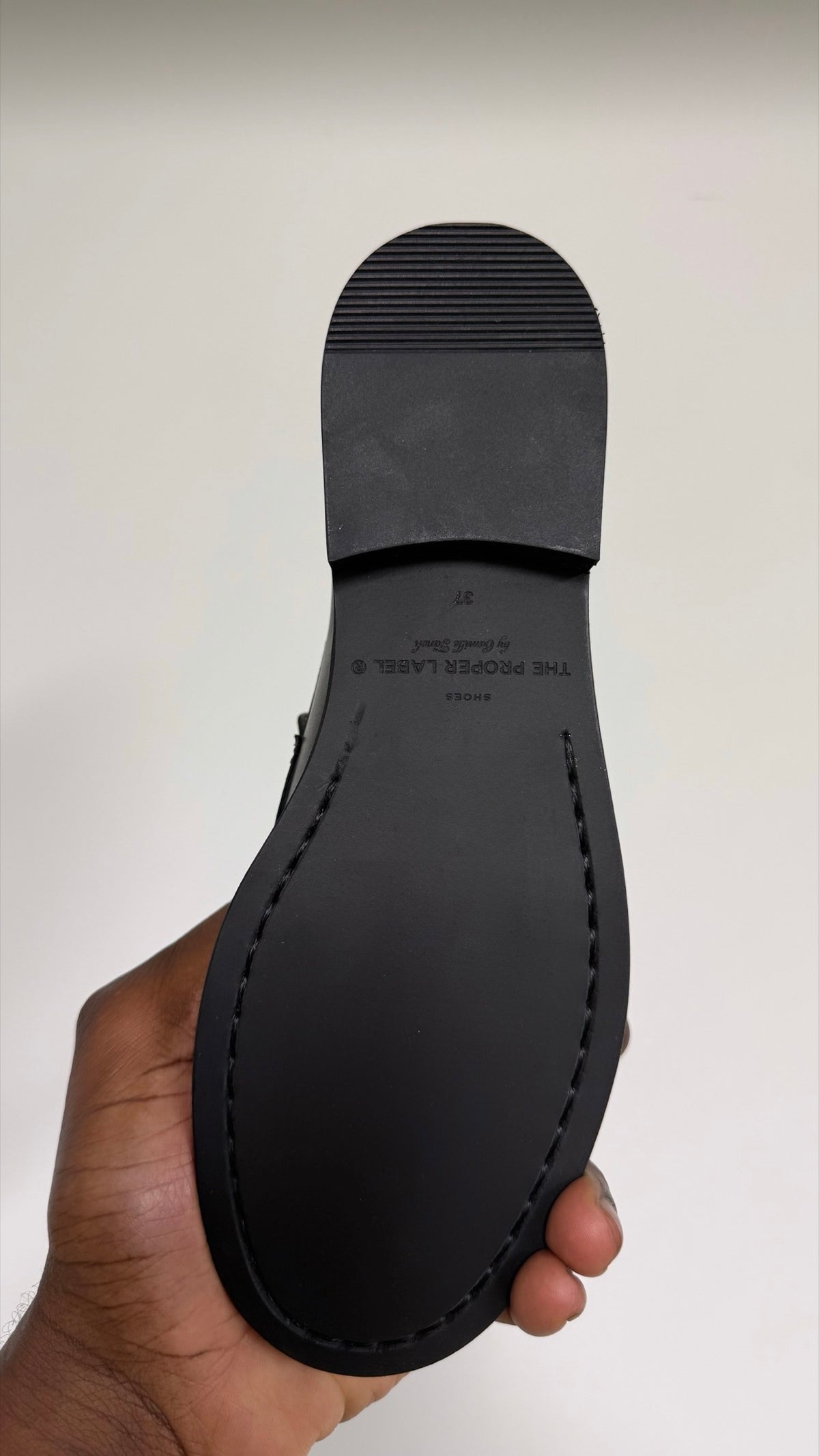 A close view of the sole and its stitched outline.