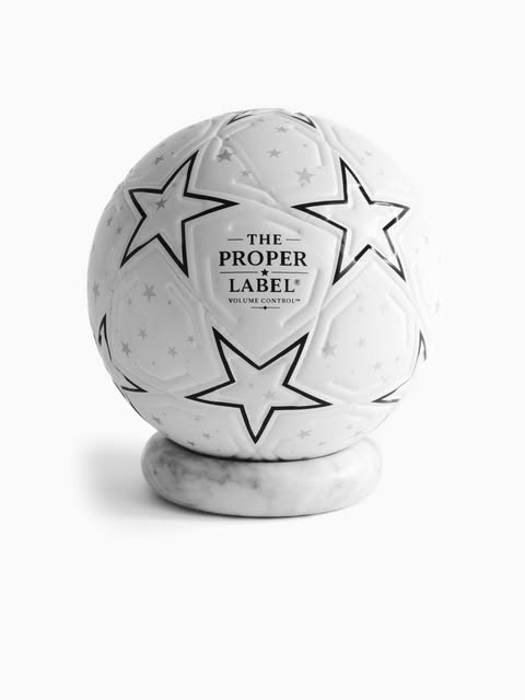 A football displayed on a white plinth.