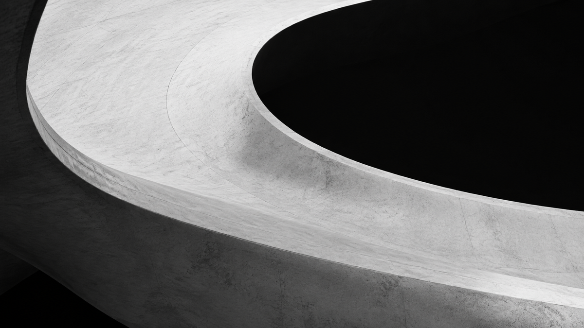Architectural study of a sweeping white concrete curve surrounding a deep black elliptical void.