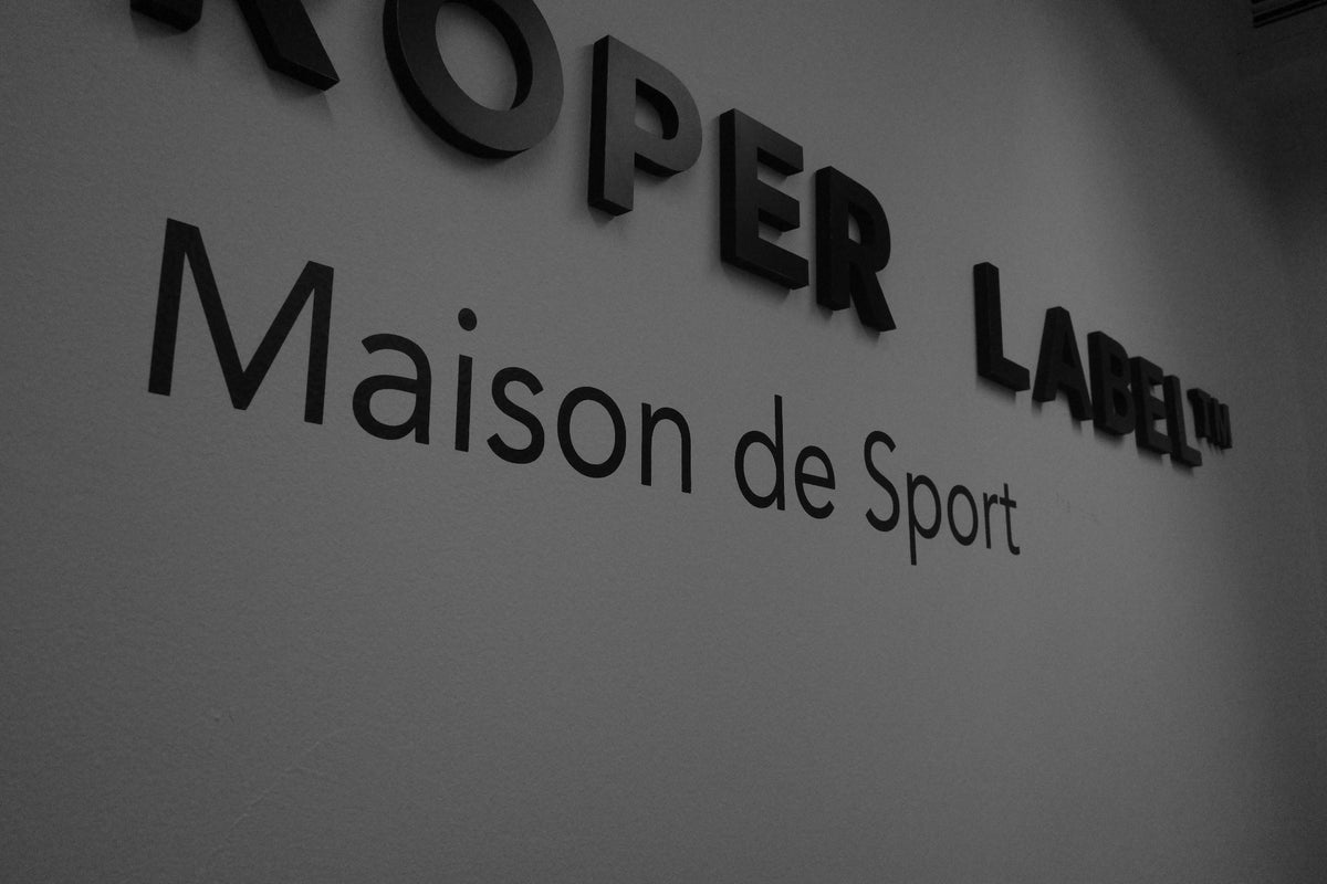 The Proper Label wall signage with Maison de Sport lettering.