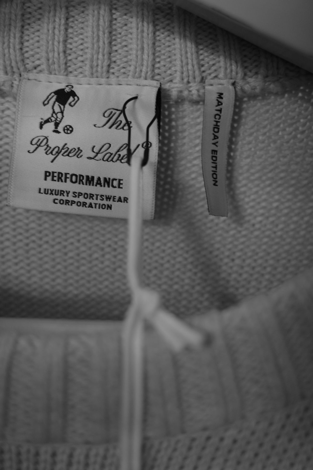 The Proper Label Performance and Matchday Edition labels on knitwear.