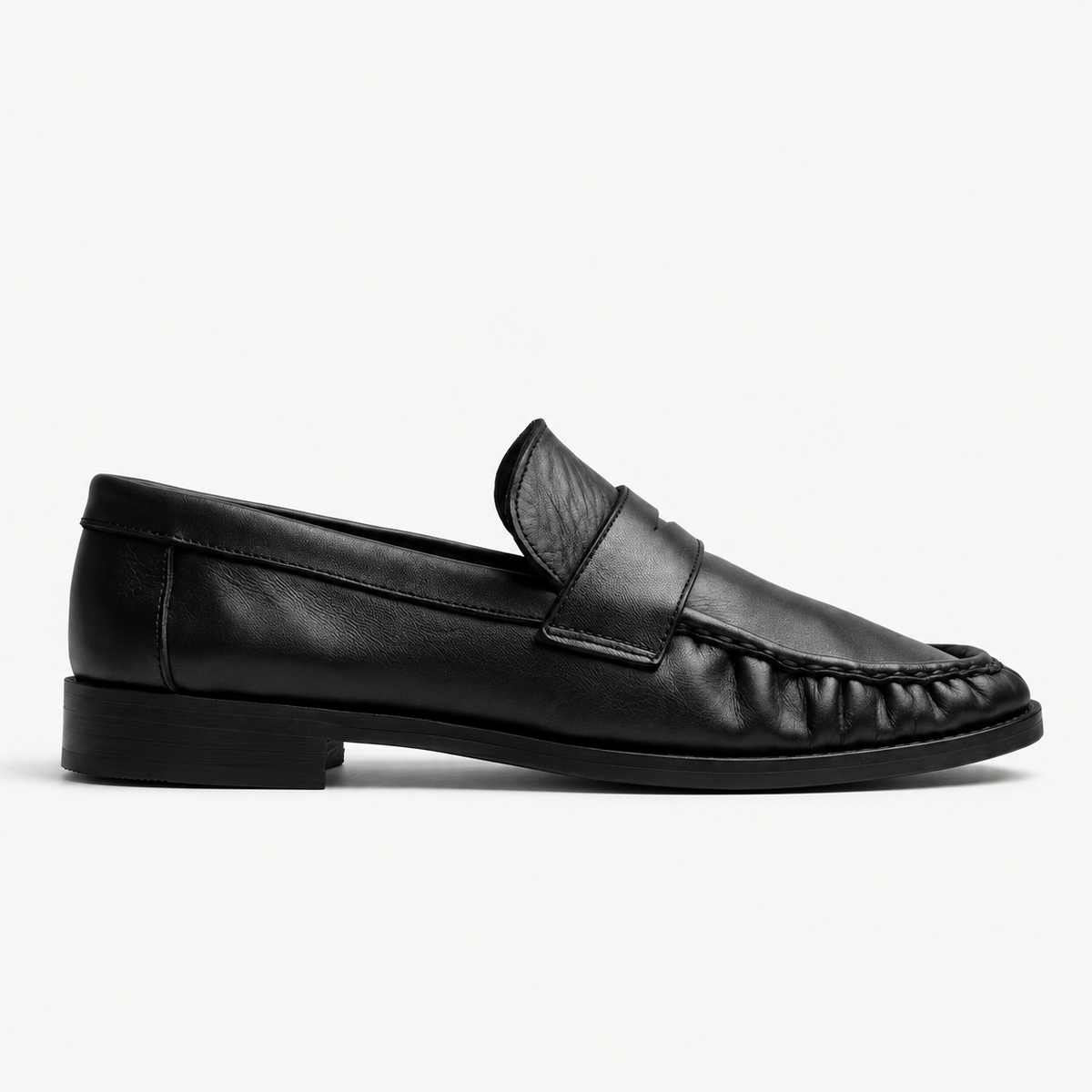 The Proper Mocassin in black leather, seen in side profile.