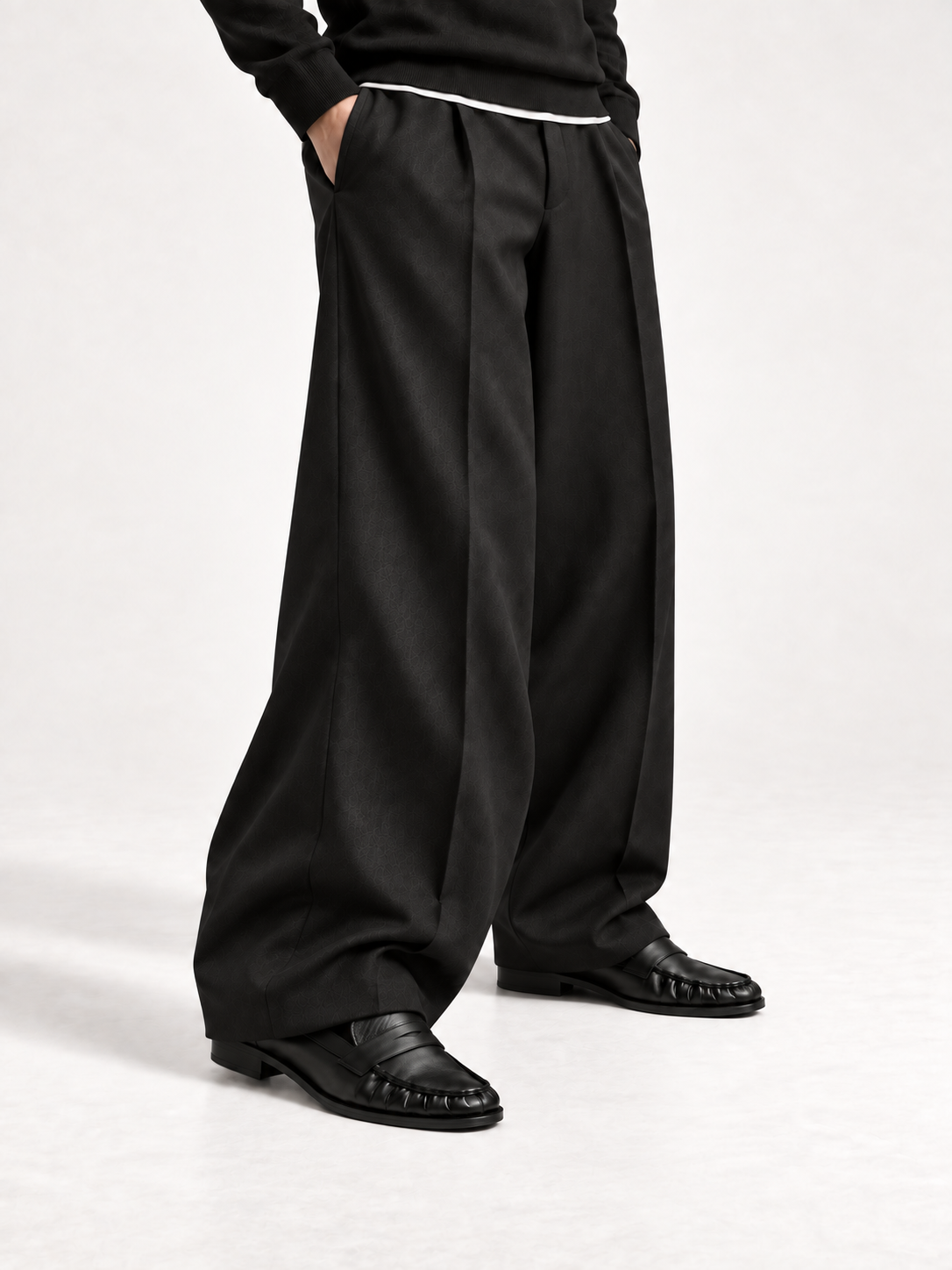 The Proper Moccasin® — Obsidian Black, second worn study with wide black trousers.
