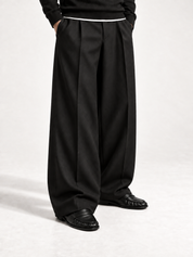 The Proper Moccasin® — Obsidian Black, wide black trousers and the V-cut saddle.