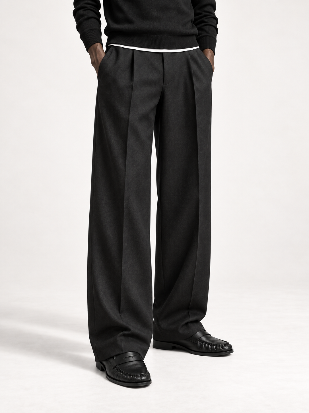 The Proper Moccasin worn with long pleated black trousers and a black knit.