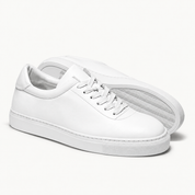 The Proper Sneaker® — white pair and wave-pattern rubber outsole.