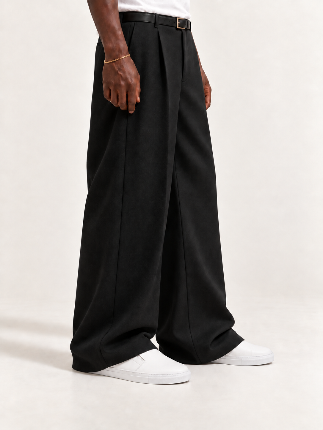 The Dove Slip-On — White, worn with long black trousers, a tucked white T-shirt, a slim belt and discreet gold-tone accessories.