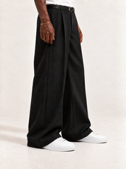 The Proper High-Top Sneaker — White, worn with long black trousers, a tucked white T-shirt, a slim belt and discreet gold-tone accessories.