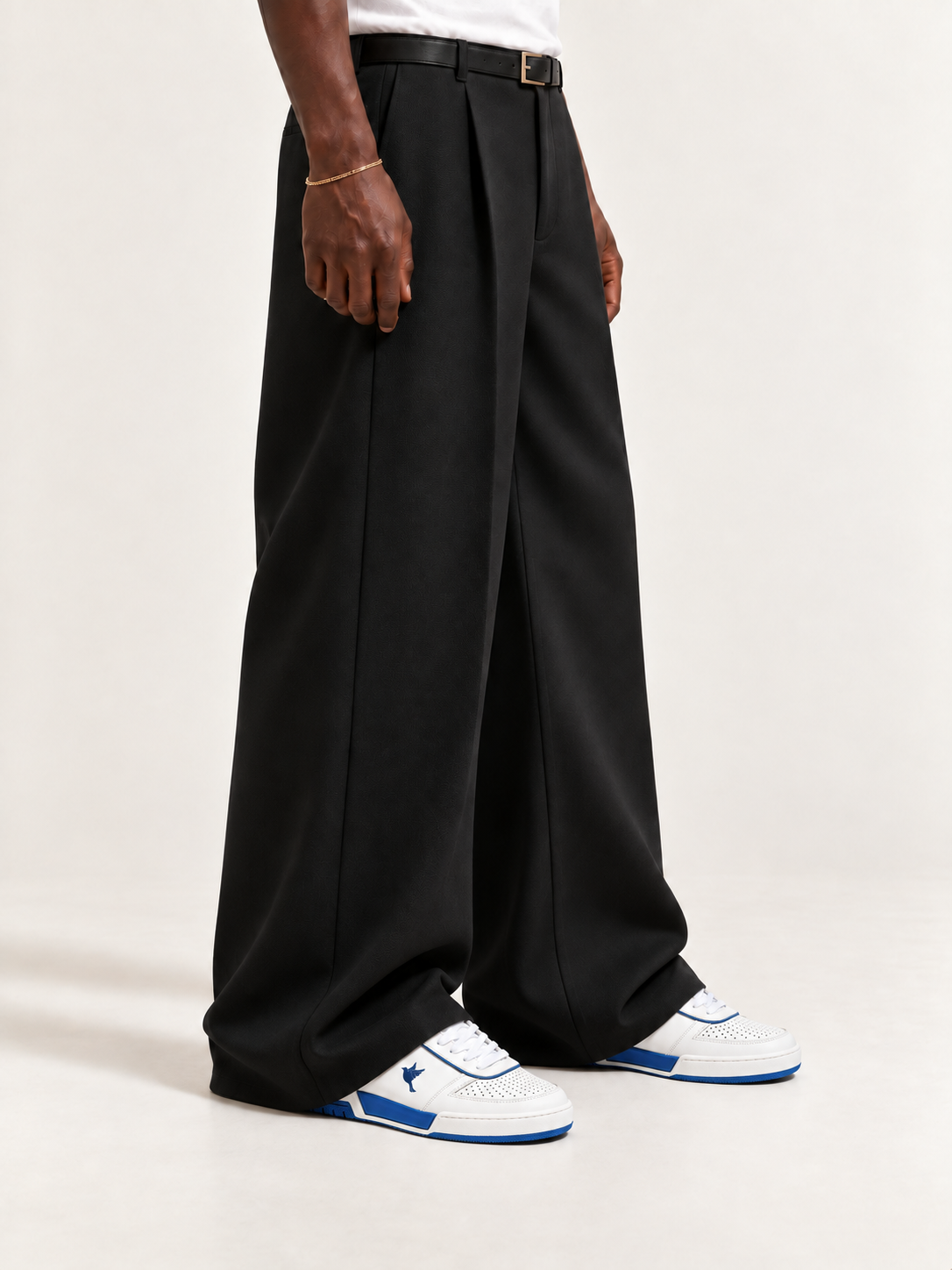 The PR003 — White / Blue, worn with long black trousers, a tucked white T-shirt, a slim belt and discreet gold-tone accessories.