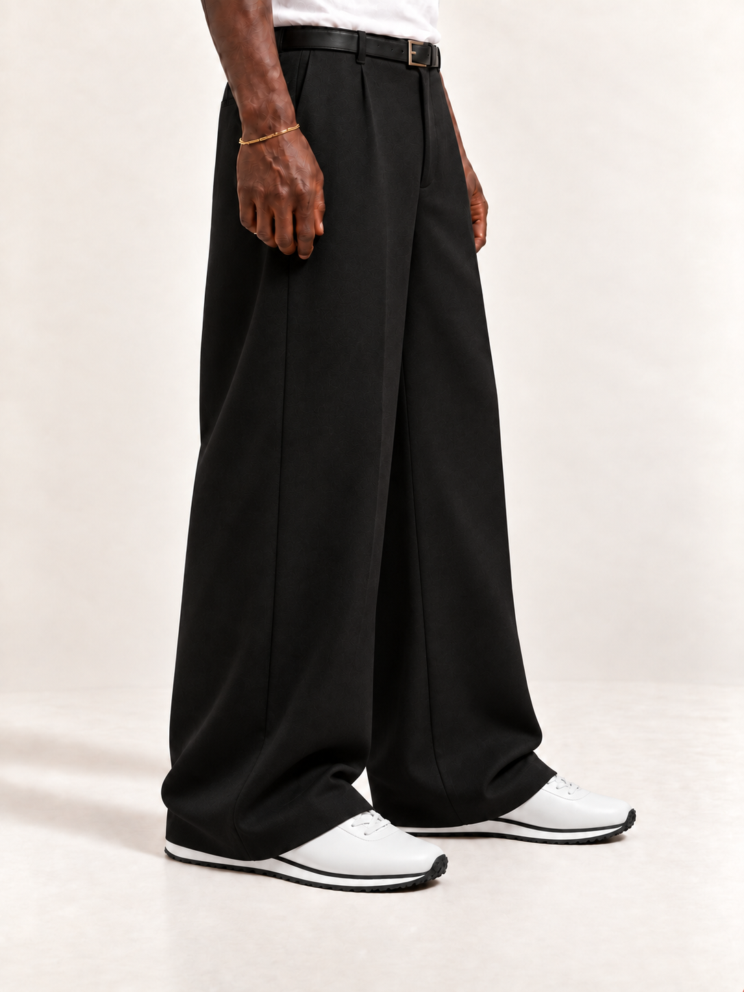 The Proper Runner — White, worn with long black trousers, a tucked white T-shirt, a slim belt and discreet gold-tone accessories.
