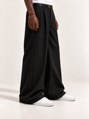 The Proper Slip-On — White, worn with long black trousers, a tucked white T-shirt, a slim belt and discreet gold-tone accessories.