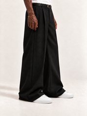 The Proper Sneaker®, worn with long black trousers, a tucked white T-shirt, a slim belt and discreet gold-tone accessories.
